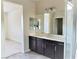 Contemporary bathroom with dark vanity, large mirror and step-in shower at 1128 Via Della Curia, Henderson, NV 89011