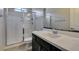 Bathroom featuring a walk-in shower, toilet, single sink with dark cabinets and chrome hardware at 1128 Via Della Curia, Henderson, NV 89011