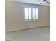 Bright bedroom with neutral walls, carpet flooring, and large window with blinds at 1128 Via Della Curia, Henderson, NV 89011