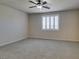 Bedroom with carpeted flooring, ceiling fan, and plantation shuttered window at 1128 Via Della Curia, Henderson, NV 89011