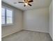 Bedroom with neutral carpet, window with plantation shutters, ceiling fan, and electrical outlets at 1128 Via Della Curia, Henderson, NV 89011