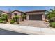Charming single-story home with a two-car garage and a beautifully landscaped front yard at 1128 Via Della Curia, Henderson, NV 89011