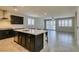 Modern open kitchen with a large island, dark cabinetry, and stainless steel appliances at 1128 Via Della Curia, Henderson, NV 89011