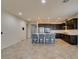 Open kitchen with stainless steel appliances, a large center island with seating, and dark wood cabinetry at 1128 Via Della Curia, Henderson, NV 89011