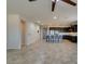 Spacious living room with tile flooring opening to kitchen with breakfast bar seating at 1128 Via Della Curia, Henderson, NV 89011