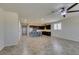 Open living room with tile flooring, ceiling fan and natural light from shuttered windows at 1128 Via Della Curia, Henderson, NV 89011