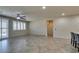 Spacious living area with tile flooring, ceiling fan, access to other rooms, and natural light at 1128 Via Della Curia, Henderson, NV 89011