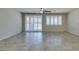 Bright living room features tile flooring, ceiling fan, and sliding glass doors with plantation shutters at 1128 Via Della Curia, Henderson, NV 89011