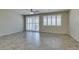 Open living space with tile floors, ceiling fan, and sliding door with plantation shutters at 1128 Via Della Curia, Henderson, NV 89011