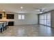 Open-concept living area combines kitchen with island and dining areas, filled with lots of light at 1128 Via Della Curia, Henderson, NV 89011