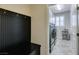 Mud room with dark bench and access to laundry room, complete with washer, dryer, and sink at 1128 Via Della Curia, Henderson, NV 89011