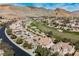 Overhead view of the neighborhood showcasing the golf course and mountain views at 11534 Glowing Sunset Ln, Las Vegas, NV 89135