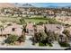 Aerial view of the property showcasing the home's facade and nearby golf course at 11534 Glowing Sunset Ln, Las Vegas, NV 89135