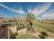 Picturesque view from the backyard of lush green golf course and distant mountains under a bright sky at 11534 Glowing Sunset Ln, Las Vegas, NV 89135