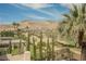 Backyard view overlooking a golf course with desert landscaping and mountain views at 11534 Glowing Sunset Ln, Las Vegas, NV 89135