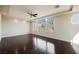 Spacious bedroom with hardwood floors and large windows offering views of the surrounding landscape at 11534 Glowing Sunset Ln, Las Vegas, NV 89135