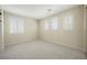 Bright bedroom featuring carpeted floors, arched windows, and plantation shutters at 11534 Glowing Sunset Ln, Las Vegas, NV 89135