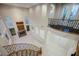 Light-filled foyer boasts a curved staircase, fireplace, and arched windows, offering a grand and inviting entrance at 11534 Glowing Sunset Ln, Las Vegas, NV 89135