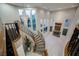 Expansive foyer featuring a curved staircase, chandelier, fireplace, and arched windows, blending luxury with architectural flair at 11534 Glowing Sunset Ln, Las Vegas, NV 89135