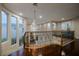 Open hallway with dark wood floors overlooking a curved staircase, chandelier, and a living room with fireplace at 11534 Glowing Sunset Ln, Las Vegas, NV 89135