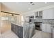 Open kitchen featuring a large island, stainless steel appliances, and gray-toned cabinetry, perfect for entertaining at 11534 Glowing Sunset Ln, Las Vegas, NV 89135