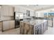 Gourmet kitchen showcasing stainless steel appliances, gray-toned cabinets, granite countertops, and a spacious island at 11534 Glowing Sunset Ln, Las Vegas, NV 89135