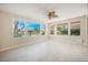 Spacious living room with multiple windows offering panoramic views of lush landscaping at 11534 Glowing Sunset Ln, Las Vegas, NV 89135