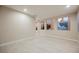 Open living room featuring tile floors and windows with views of the staircase and backyard at 11534 Glowing Sunset Ln, Las Vegas, NV 89135