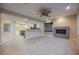 Open living room featuring a modern fireplace, ceiling fan, and built-in shelving at 11534 Glowing Sunset Ln, Las Vegas, NV 89135