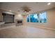 Bright living room with fireplace, built-in shelving, and a serene view of the backyard at 11534 Glowing Sunset Ln, Las Vegas, NV 89135