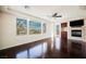 Bright living room featuring a fireplace, built-in shelves, hardwood floors, and large windows with scenic views at 11534 Glowing Sunset Ln, Las Vegas, NV 89135