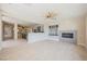 Open-concept living room with tile floors, fireplace, and views of kitchen, wine cellar and backyard at 11534 Glowing Sunset Ln, Las Vegas, NV 89135