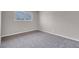 Bedroom featuring plush gray carpeting, neutral walls, and a barred window at 1189 Blankenship Ave, Las Vegas, NV 89106