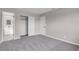 Neutral bedroom features gray carpet, closet, and doorway to ensuite bathroom at 1189 Blankenship Ave, Las Vegas, NV 89106