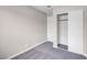 Neutral bedroom features gray carpet, a closet, and a white painted door at 1189 Blankenship Ave, Las Vegas, NV 89106