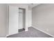 Neutral bedroom features gray carpet, a closet, and a white painted door at 1189 Blankenship Ave, Las Vegas, NV 89106