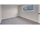 Neutral bedroom features gray carpet, a window with security bars, and base trim at 1189 Blankenship Ave, Las Vegas, NV 89106