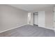 Neutral bedroom features gray carpet, closet, and doorway to ensuite bathroom at 1189 Blankenship Ave, Las Vegas, NV 89106