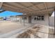 View under carport of entrance to cozy single story home with barred windows at 1189 Blankenship Ave, Las Vegas, NV 89106