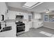 A stylish kitchen with stainless appliances, white cabinetry, and a modern ceiling fan at 1189 Blankenship Ave, Las Vegas, NV 89106
