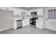 Updated kitchen with stainless steel dishwasher and range, plus modern white cabinetry at 1189 Blankenship Ave, Las Vegas, NV 89106