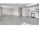Bright, open-concept living space with modern gray floors and a glimpse of the updated kitchen at 1189 Blankenship Ave, Las Vegas, NV 89106