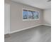 View of a living room featuring grey wood flooring and a bright window at 1189 Blankenship Ave, Las Vegas, NV 89106