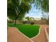 Spacious backyard with artificial grass and gravel paths is easy to maintain at 1350 Rossini St, Henderson, NV 89052