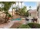 Private backyard features a lovely pool and dining area surrounded by mature landscaping at 1350 Rossini St, Henderson, NV 89052