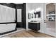 Modern bathroom with a freestanding tub, sleek black vanity, and elegant chandelier lighting at 1350 Rossini St, Henderson, NV 89052