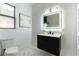 Well lit bathroom with a modern vanity, toilet, and artistic decorative touches at 1350 Rossini St, Henderson, NV 89052