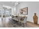Bright dining room with modern lighting and decor, featuring a wood table and ample seating at 1350 Rossini St, Henderson, NV 89052