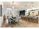 Open-concept kitchen and dining area featuring a large island with bar seating and modern finishes at 1350 Rossini St, Henderson, NV 89052