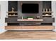 Stylish living room featuring custom wall decor, floating shelves, and a cozy electric fireplace at 1350 Rossini St, Henderson, NV 89052